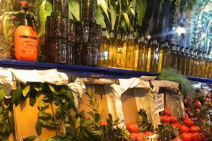Herbs, spices and olive oil bottles at an İstanbul market, ingredients for a local Turkish home cooking class