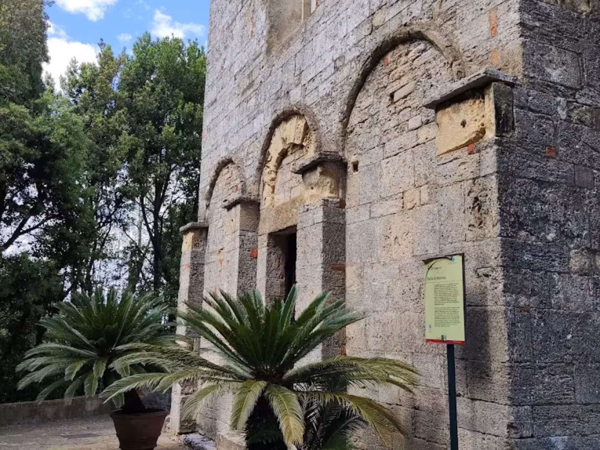 Discover the historic charm of a Tuscan abbey near Pisa, surrounded by lush greenery and ancient stone architecture.