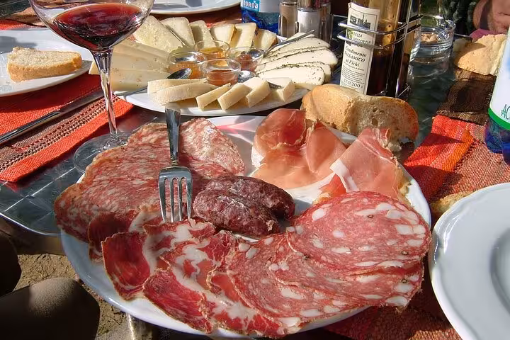 Enjoy a delectable Tuscan lunch with cured meats, cheeses, wine, and bread on the Florence Vespa tour.