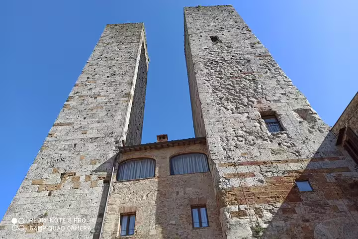 Medieval stone towers rising above a historic Tuscan village, a cultural stop on a private Chianti hills and wine tour