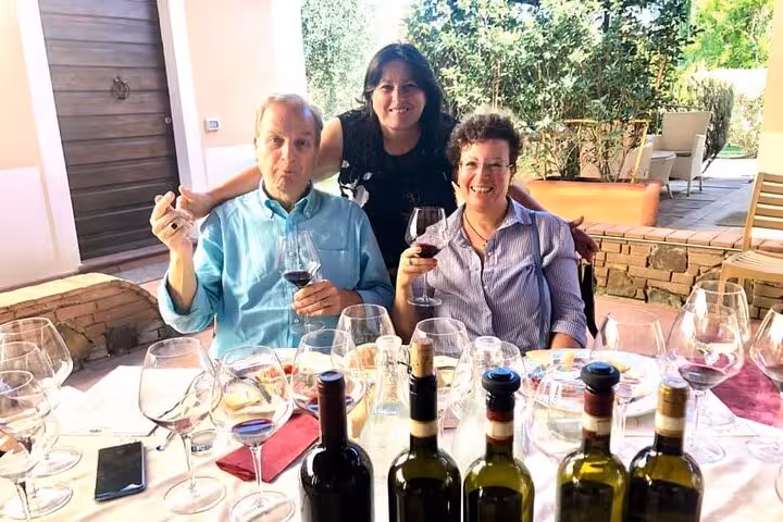 Tourists enjoying a wine tasting experience with a selection of Tuscan wines.