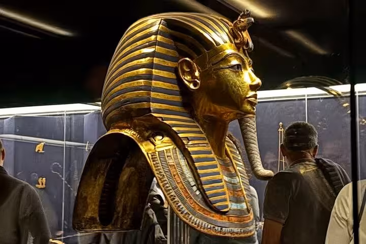 Side view of Tutankhamun’s gold mask exhibit at Grand Egyptian Museum, included half-day tour tickets