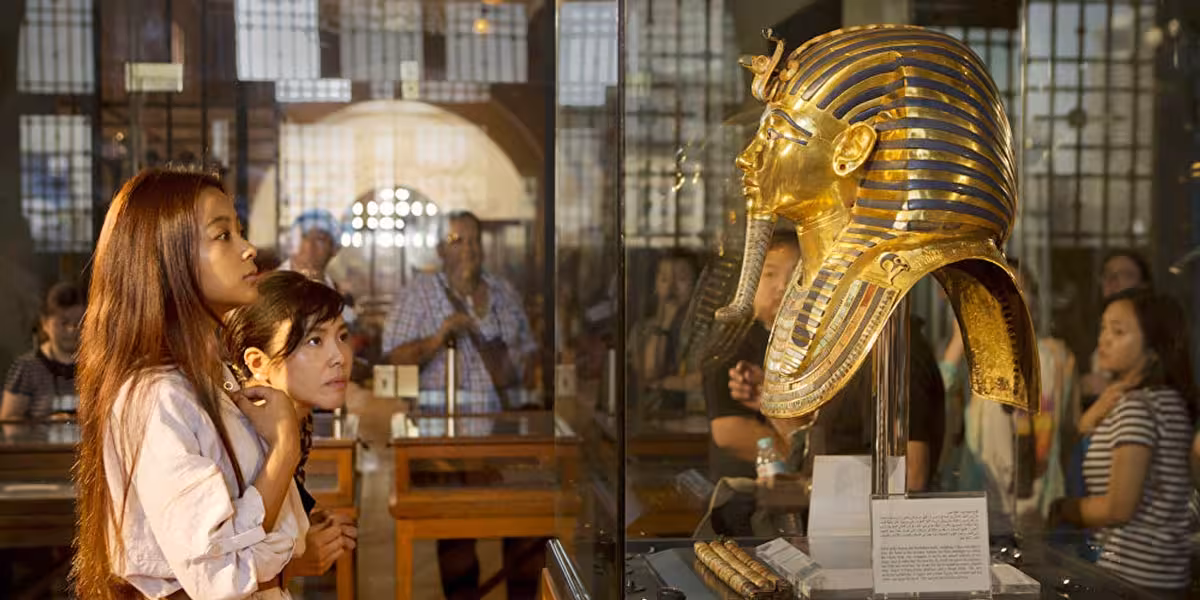 Visitors viewing Tutankhamun’s golden mask at the Egyptian Museum Cairo on a private Giza tour with shopping