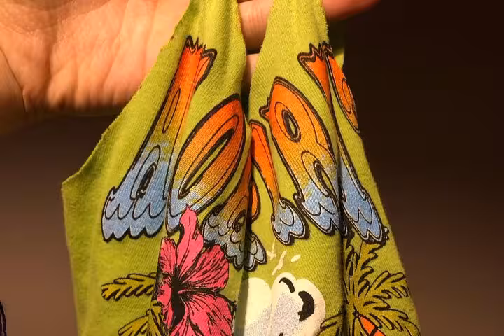 Close-up of cut T-shirt handles forming a DIY tote bag, upcycle T-shirt to tote bag sustainable workshop