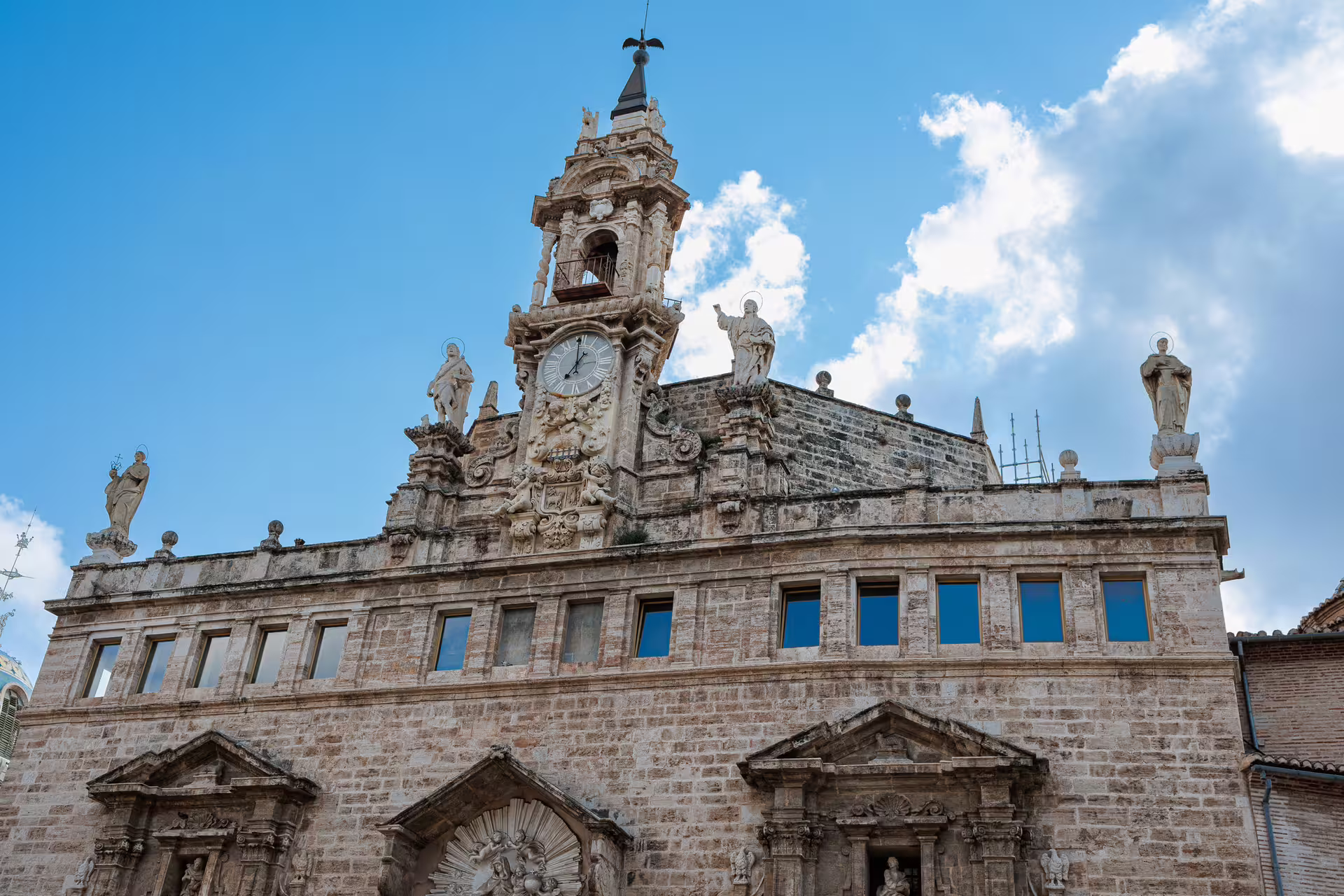 Baroque clock tower and stone facade of Valencia Cathedral on a 1-day walking tour with multilingual audioguide