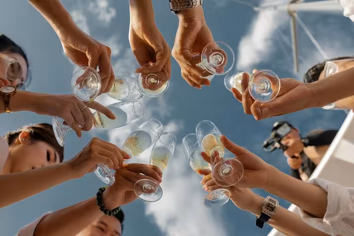 Group toast with wine glasses under the sky during a Valencia Ruzafa evening tapas and wine tour