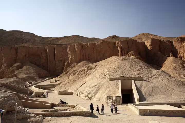 Visitors at Valley of the Kings tomb entrance in Luxor, part of historical day tour by bus from Hurghada