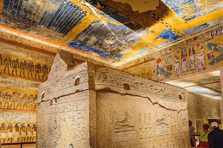 Ancient sarcophagus under colorful ceiling in Valley of the Kings tomb, private Luxor tour from Marsa Alam