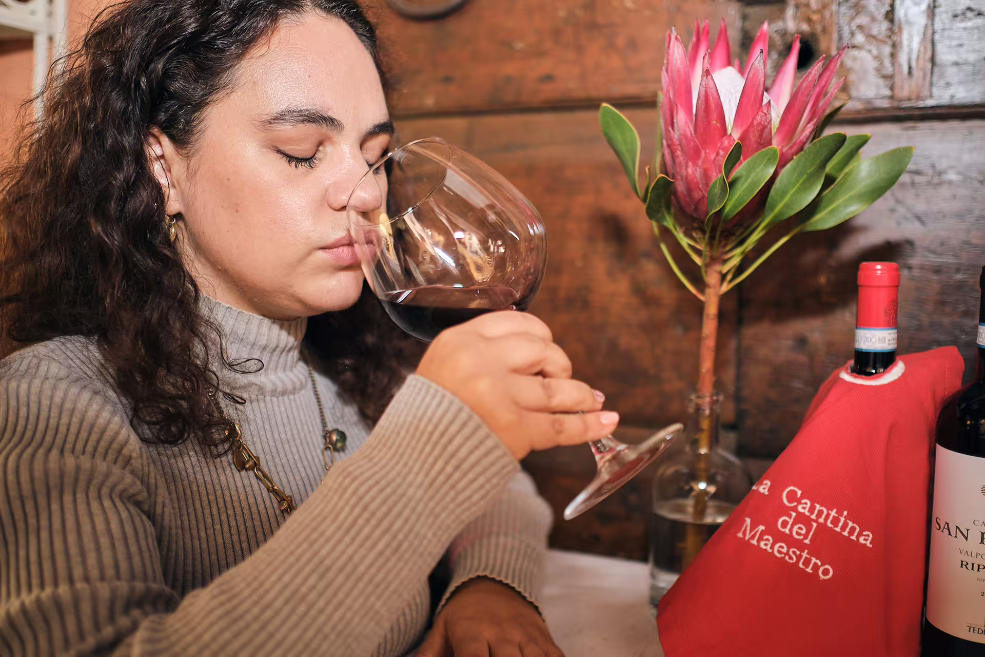 Close-up of guest smelling Valpolicella red wine on Verona tasting tour near Juliet’s House with local wines