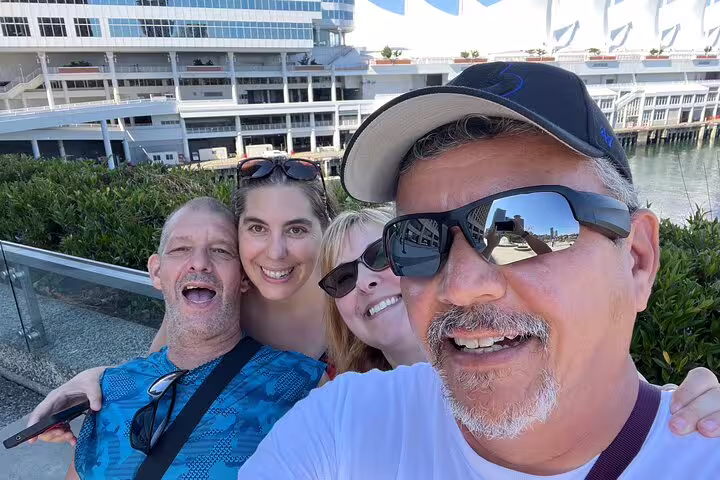 Group selfie by Canada Place waterfront in Vancouver, a fun stop on the Gastown scavenger hunt experience