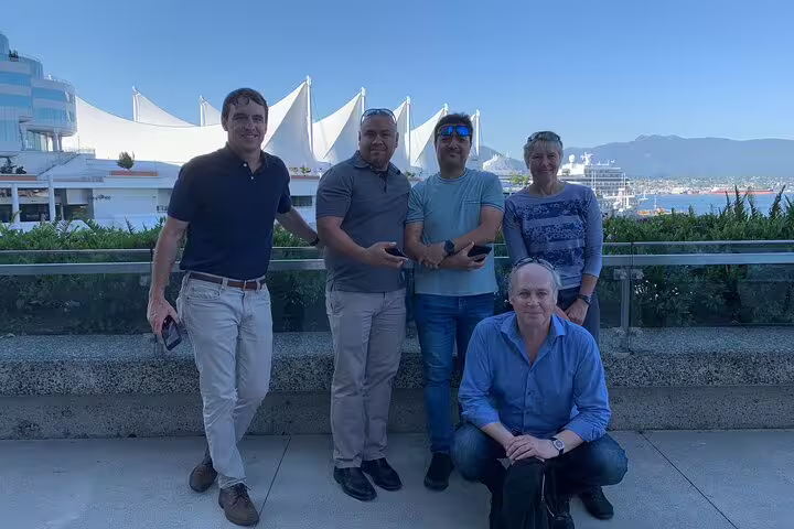 Friends pose by Canada Place on Vancouver waterfront, a fun stop on the Gastown scavenger hunt tour