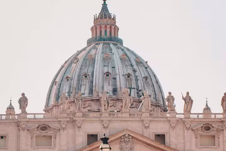 Majestic view of St. Peter's Basilica dome, showcasing architectural grandeur at Vatican City.