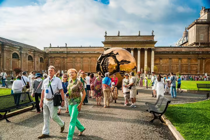 Tour group exploring Vatican Museums courtyard with Sphere Within Sphere sculpture on Exclusive Sistine Chapel fast track entrance tour