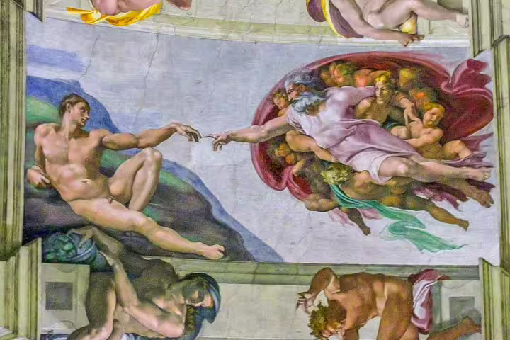 Tourists admire Michelangelo’s Creation of Adam fresco on the Sistine Chapel ceiling during a guided Vatican Museums visit in Rome