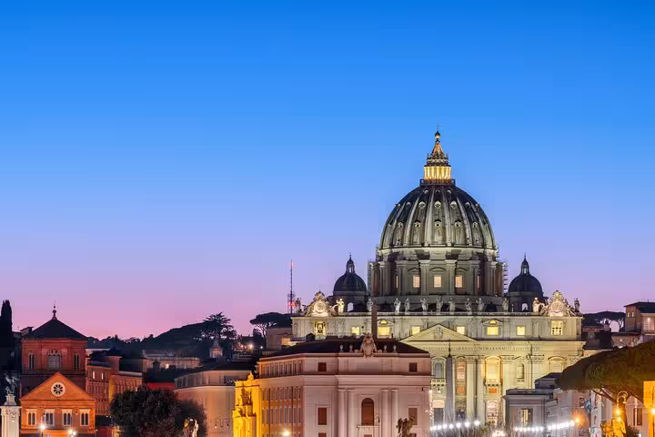 St Peter’s Basilica dome at sunset near Vatican Museums, ideal for skip-the-line hosted entry audio tour