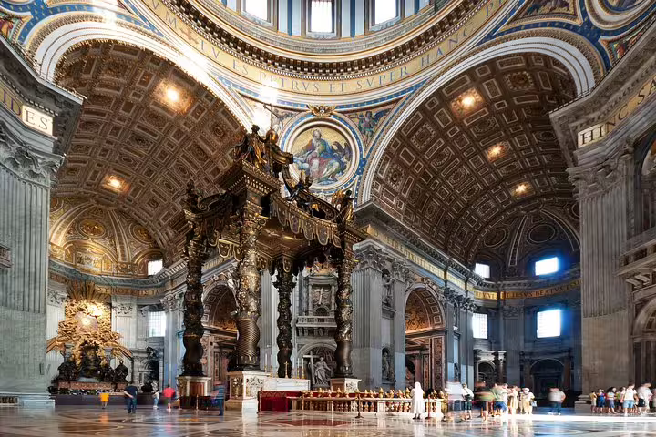 Tour group gathers beneath Bernini’s Baldachin in St Peter’s Basilica on exclusive Vatican Museums Sistine Chapel fast track tour