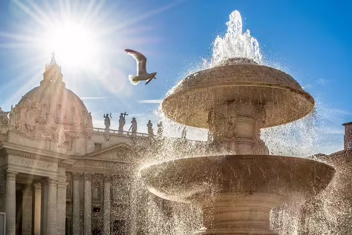 Sunlit fountain and St Peter’s Basilica dome in Vatican City on exclusive Sistine Chapel fast track entrance tour