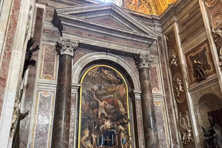 Stunning mural and columns in St Peter's Basilica, showcasing Renaissance art on a Vatican small group private tour.
