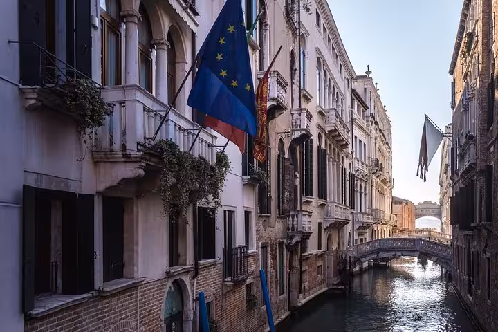 Charming Venetian canal flanked by historic buildings, perfect for a romantic gondola ride on your guided tour.