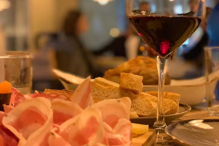 Indulge in Italian cuisine with charcuterie and wine on the Venice to Milano scenic transfer.