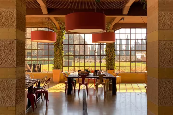 Elegant dining area in a rustic Italian villa with large windows showcasing scenic countryside views for a memorable Venice to Milano transfer.