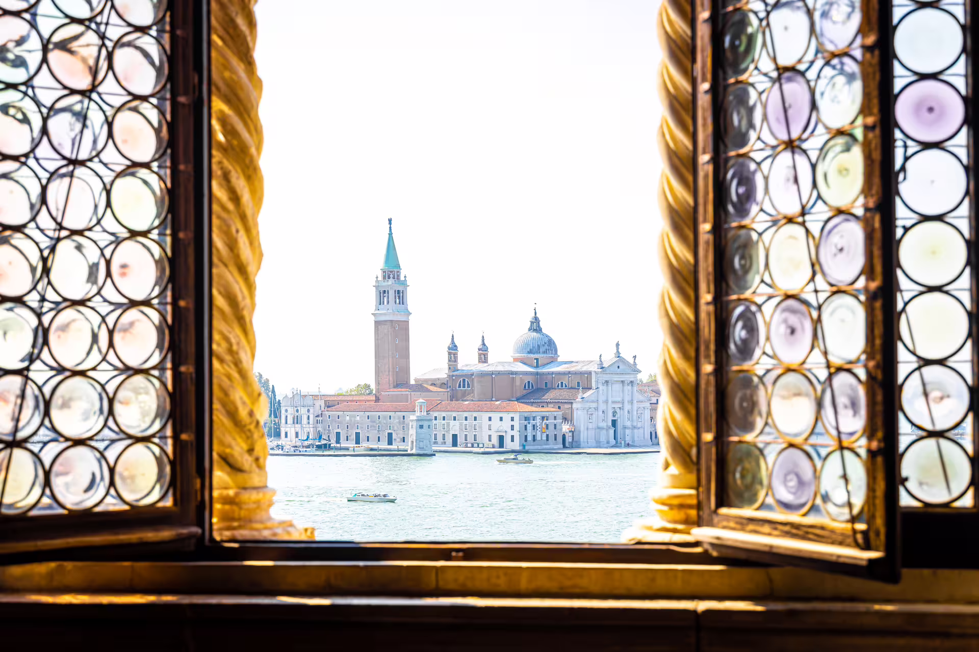 View across the Venetian lagoon from ornate palace windows on a private Venice tour with skip-the-line St. Mark’s Bell Tower tickets