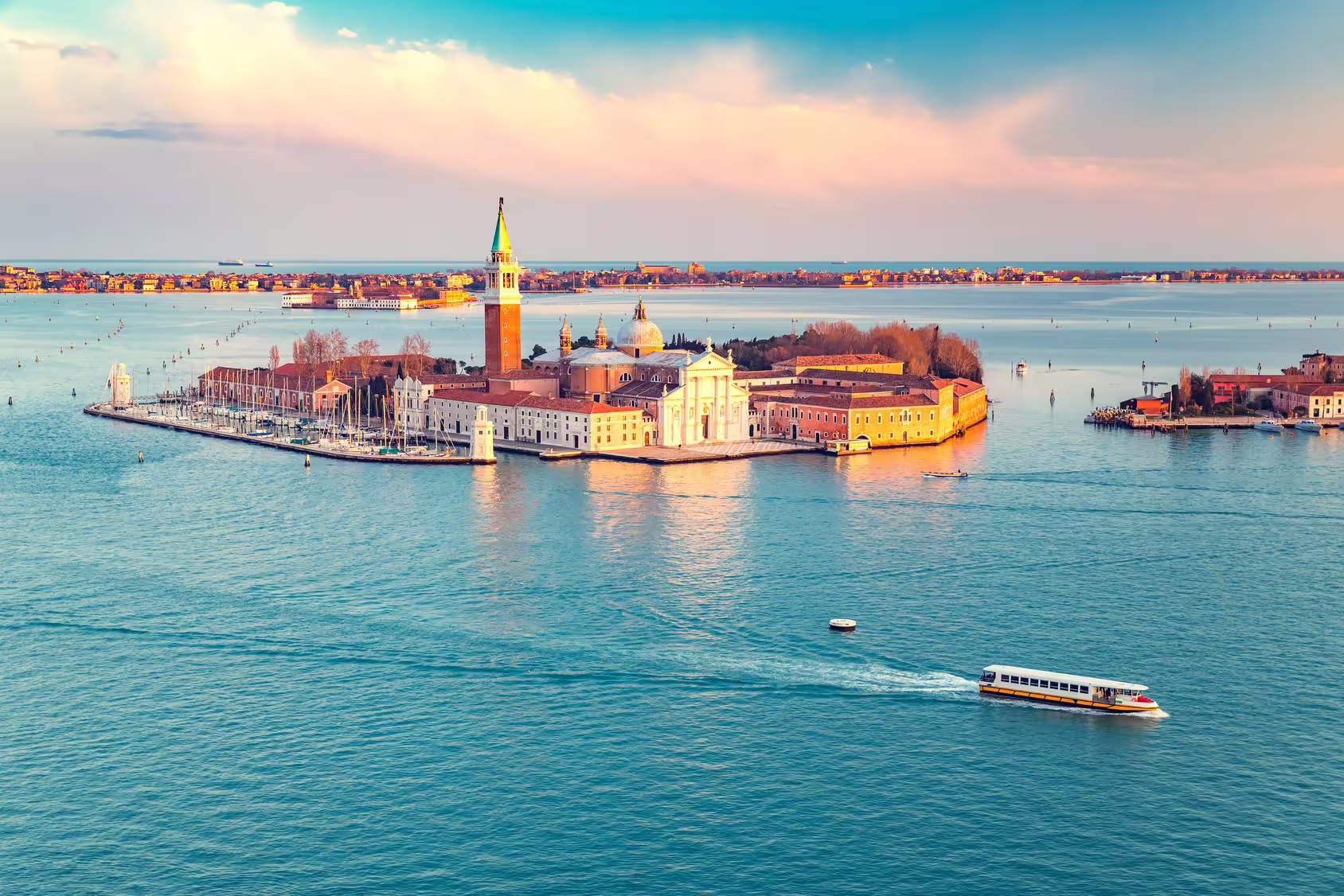 Sunset view of San Giorgio Maggiore island and lagoon seen from St. Mark’s Bell Tower on a private Venice sightseeing tour