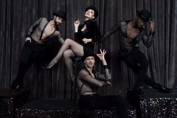 Elegant burlesque dancers in sparkling black outfits and hats onstage at Verissima cabaret experience in Rome