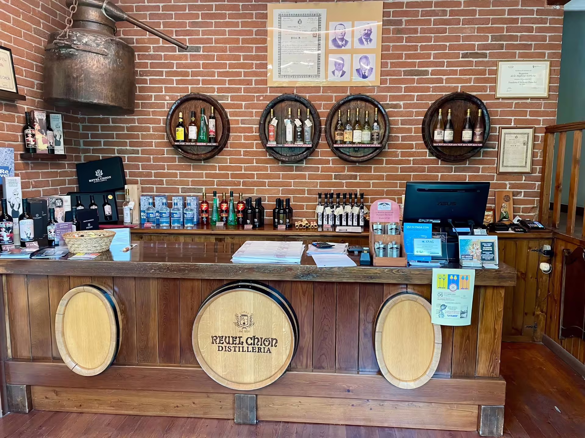 Discover the charming tasting room at a Turin distillery, showcasing a wide selection of vermouth and spirits.