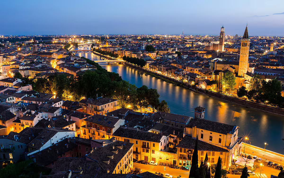 Panoramic night view of Verona and the Adige River, a must-see city on a 4-day Lake Garda holiday itinerary