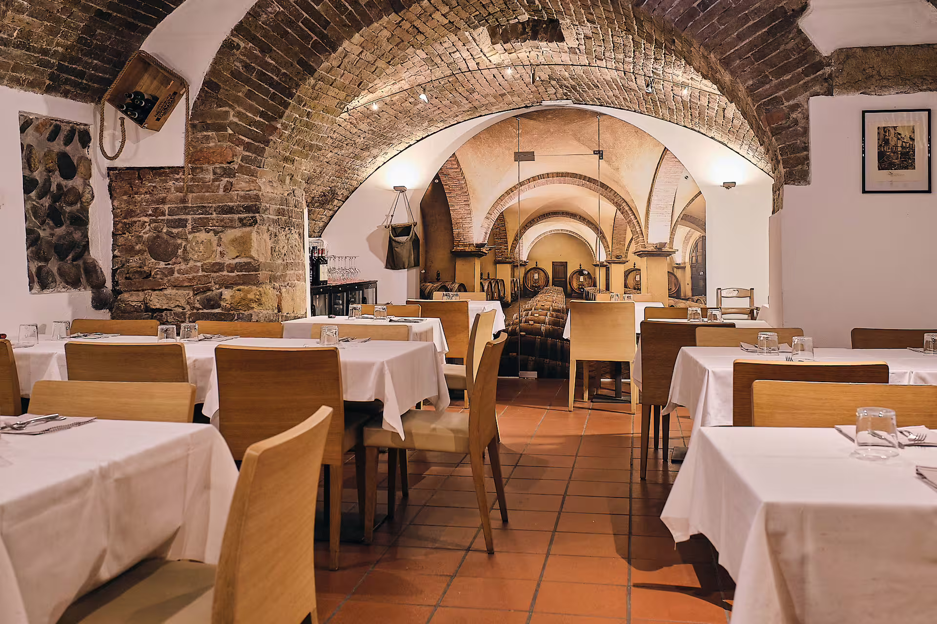 Rustic vaulted wine cellar dining room for a Verona wine tasting tour near Juliet’s House with barrel views