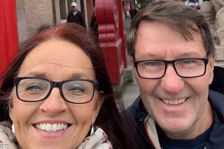 Smiling couple selfie on Victoria scavenger hunt and city highlights walking tour near downtown landmarks