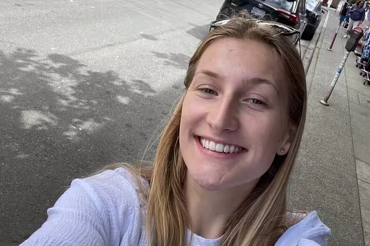 Smiling traveler selfie on Victoria scavenger hunt and city highlights walking tour, exploring downtown streets