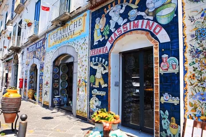 Vibrant ceramic shopfronts in Vietri, showcasing traditional Amalfi Coast craftsmanship and colorful street art.