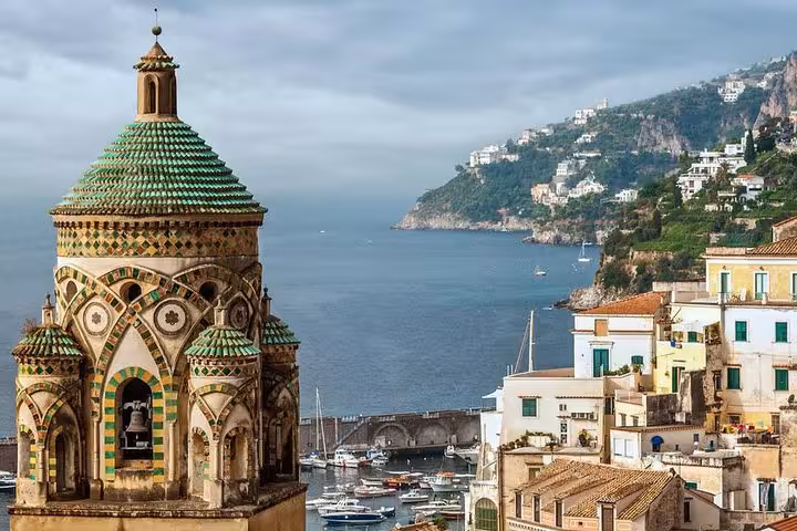 Stunning view of Vietri's colorful dome and coastal village with serene sea backdrop on the Amalfi Coast tour.