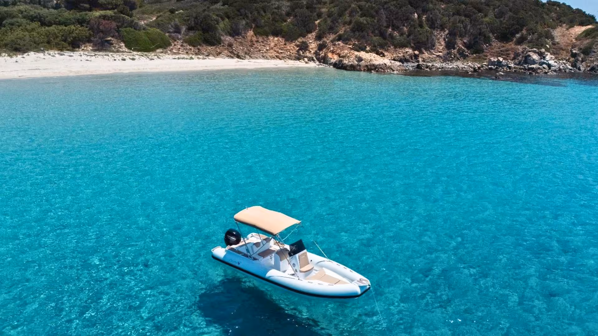 RIB boat floating on clear blue waters near Villasimius beach, perfect for a serene group adventure.