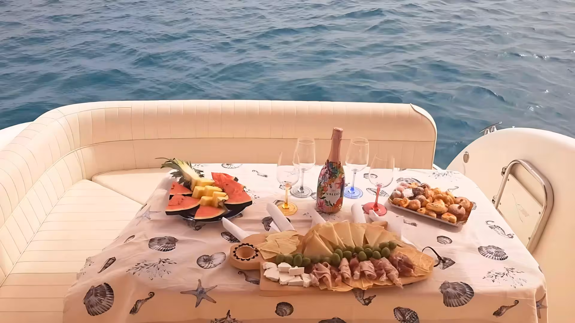 Luxurious spread of fruits and champagne onboard a private speedboat tour in Villasimius, Sardinia.