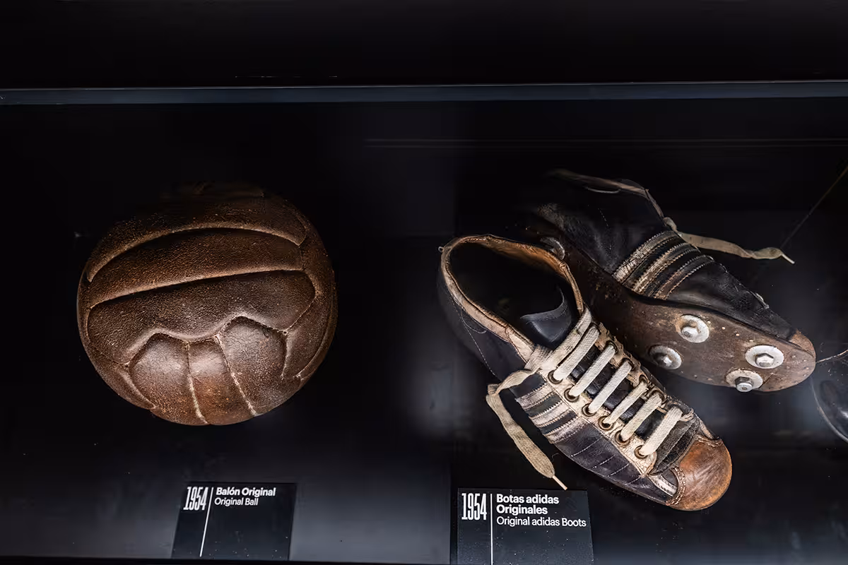Vintage 1954 football and adidas boots on display at Madrid Legends, Home of Football museum tour