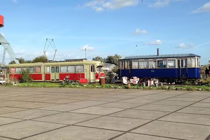 Vintage train carriages at NDSM area in Amsterdam Noord, featured on a private guided contemporary bike tour