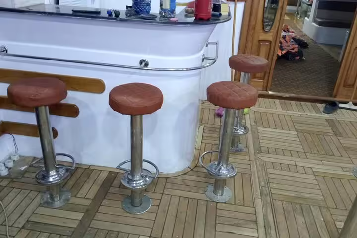 VIP boat bar area with stools on Marsa Alam Sataya snorkeling day trip with dolphin watching and lunch