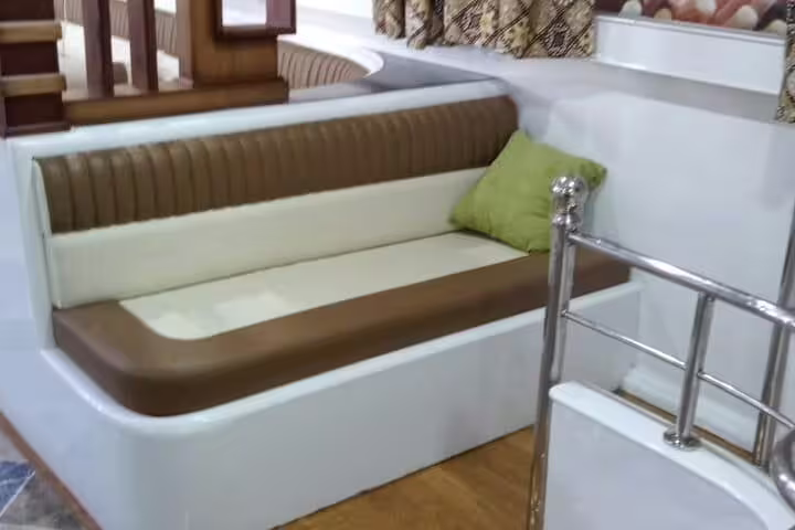 Padded bench seating on VIP boat deck for Hurghada Dolphin House snorkeling and Red Sea cruise