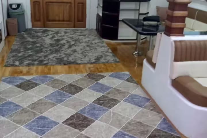 Spacious VIP boat interior with rugs and seating area for Hurghada Dolphin House snorkeling tour