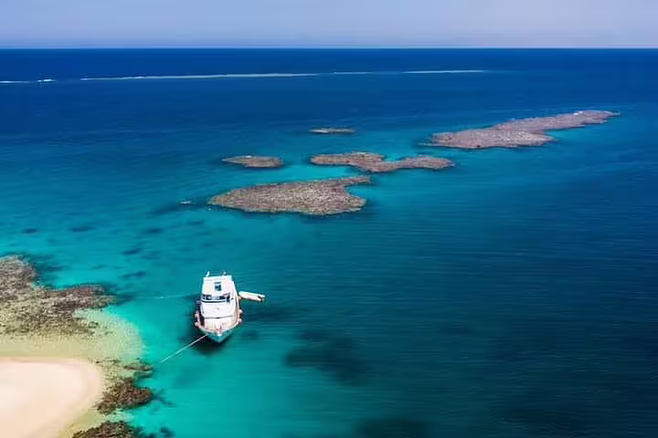 VIP boat anchored in turquoise Sataya Reef lagoon near Marsa Alam, Red Sea snorkeling day trip