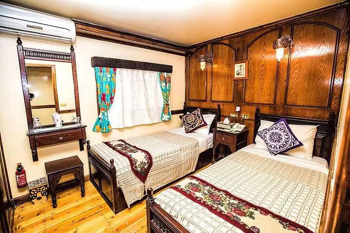 Twin-bed cabin on VIP Dahabiya Nile cruise Luxor to Aswan 4 nights featuring wood interior and AC comfort