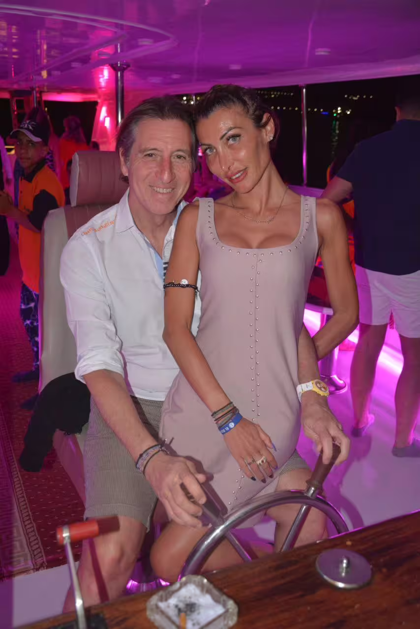 Couple enjoying nightlife on a VIP dinner cruise boat in Sharm El Sheikh with onboard lights and Red Sea views