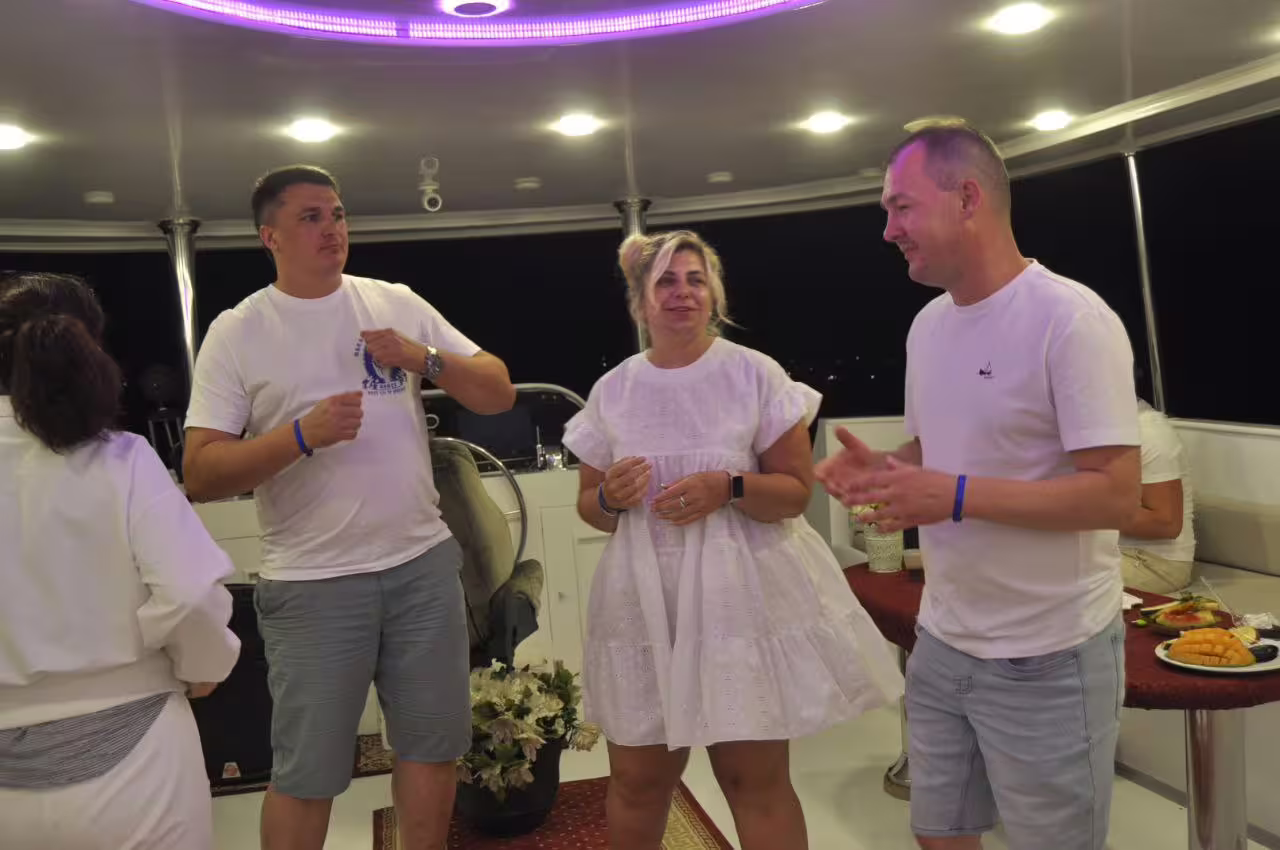 Guests socializing on VIP dinner cruise boat in Sharm El Sheikh at night with snacks, Red Sea cruise