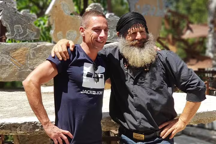 Two men smiling and posing outdoors during a VIP luxury private 4x4 tour, showcasing cultural connections.