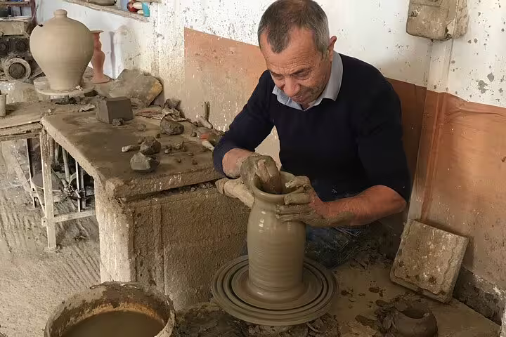 Artisan crafting pottery on a wheel during a VIP Luxury Private Tour with LandRover 4x4 excursion.