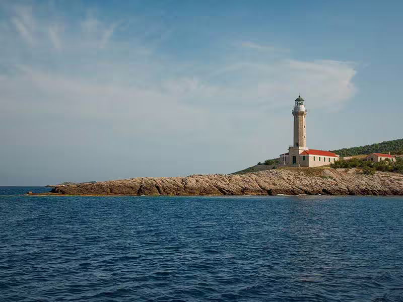 Lighthouse on rocky Adriatic coast near Vis, scenic stop on Vis and Hvar boat tour with Blue Cave highlight