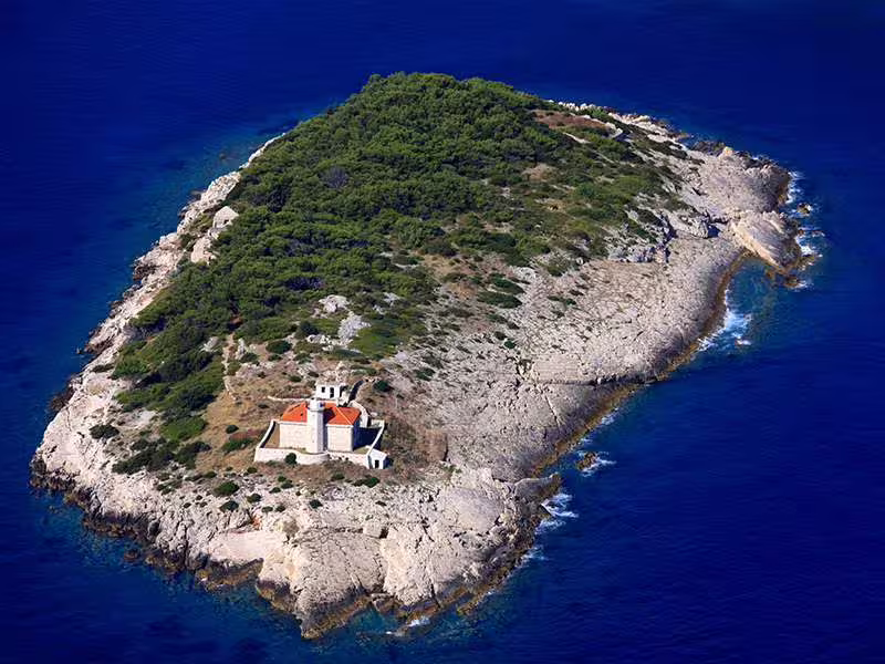 Aerial view of small rocky islet near Vis, Croatia, a photo stop on Vis and Hvar boat tour to the Blue Cave